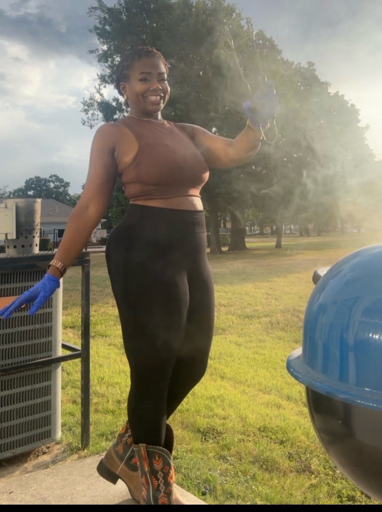 Nikki Angel smiling at her backyard grill